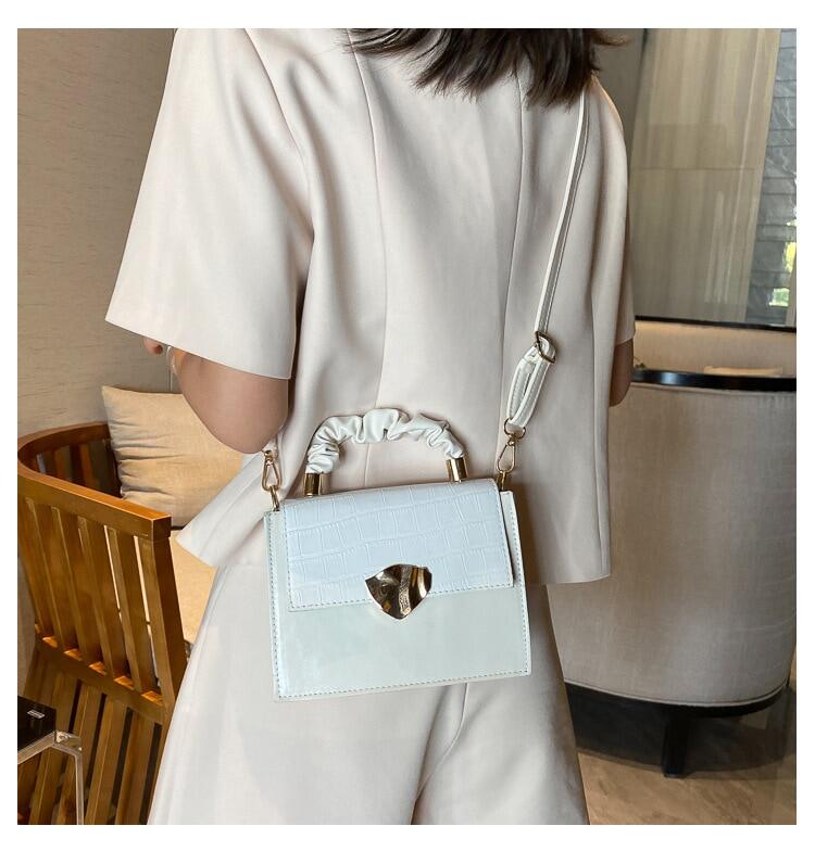 Designer women's stone pattern crossbody handbag by BACKUPMYFILESNOW® with a sleek, stylish design and adjustable strap.