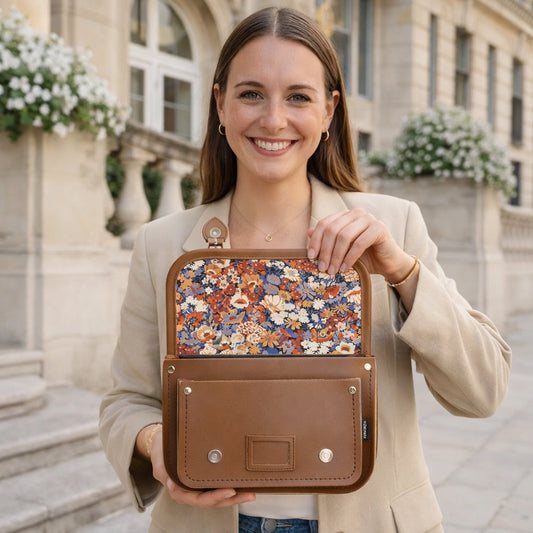 Zatchels floral-lined chestnut leather midi satchel with a structured shape and top handle, featuring a floral interior pattern.