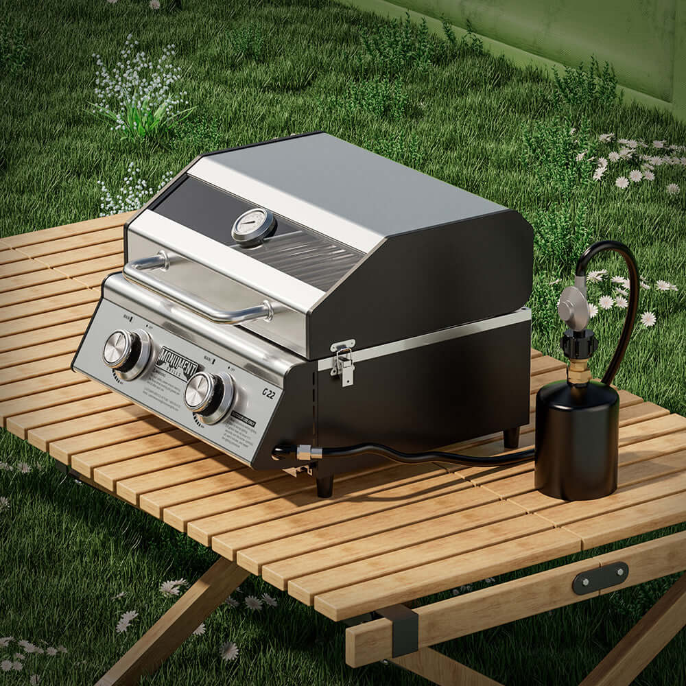 Stainless Monument Grills G22 tabletop propane gas grill with compact design and stainless steel lid and cooking surface.