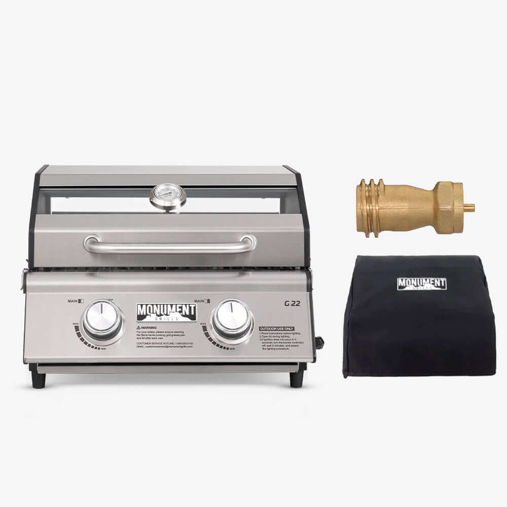 Stainless G22 Monument Grills tabletop propane gas grill with lid and 1 lb tank adapter, perfect for outdoor cooking.