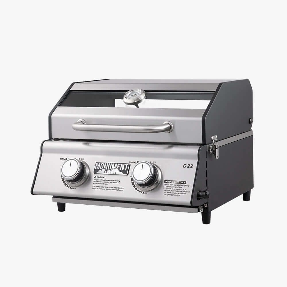 Stainless G22 Monument Grills tabletop propane gas grill with cooking surface and control knobs, ideal for outdoor grilling.