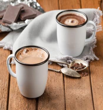 A steaming cup of hot chocolate drink from AmBari Nutrition, showcasing a rich, creamy beverage in a mug.