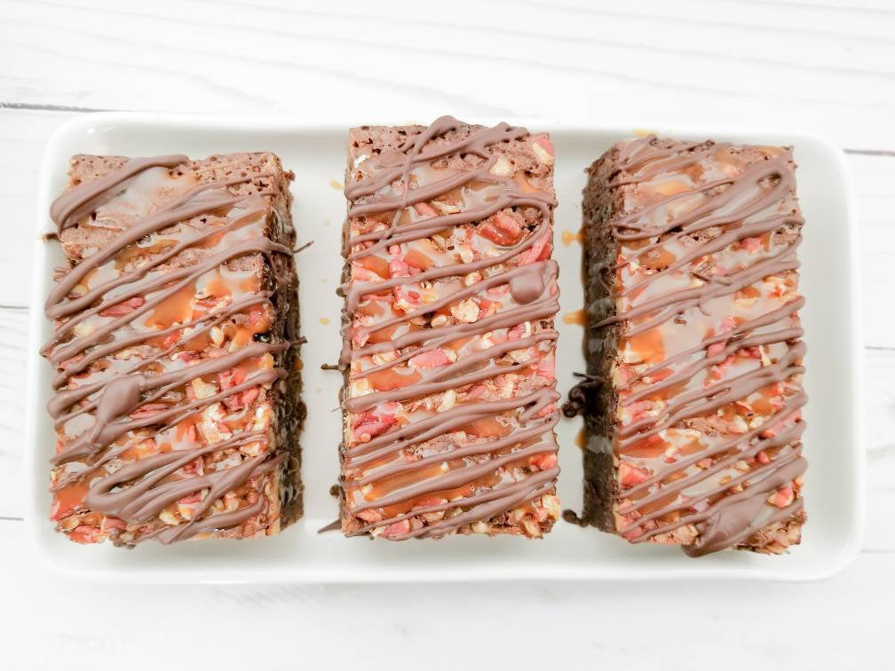 Chocolate turtle brownies from Let's Get Baked Artisan Desserts, featuring rich chocolate, caramel, and pecans in a decadent cake.