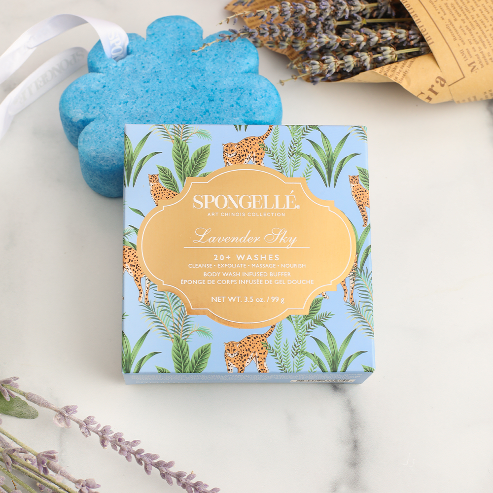 Lavender Sky Body Wash Infused Buffer by Spongellé featuring a lavender-colored sponge with floral accents and lavender scent.