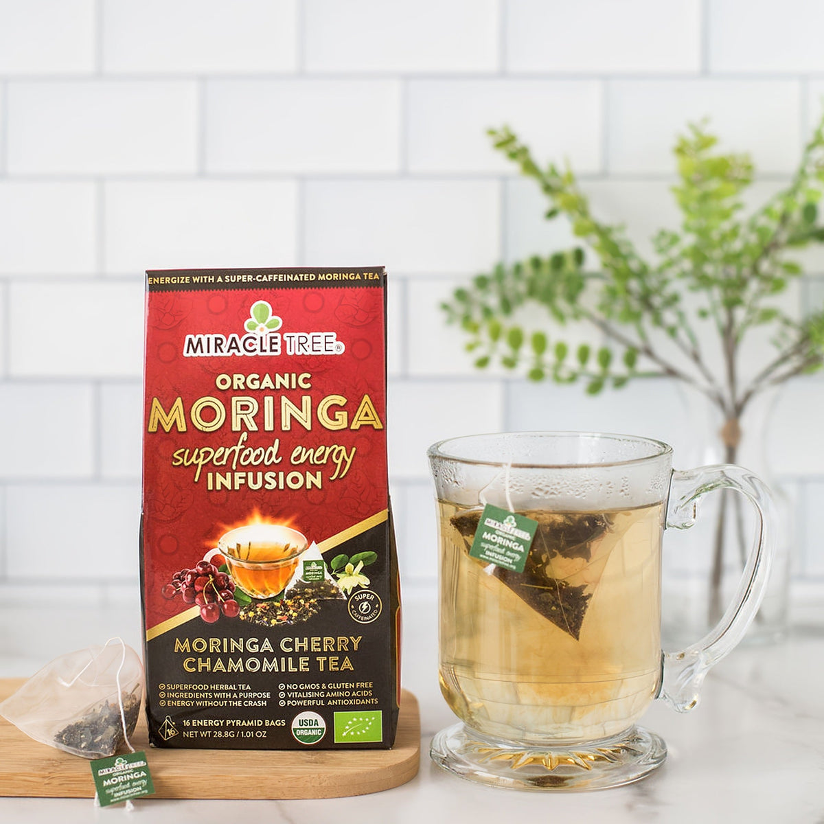 Organic Miracle Tree Moringa Energy Tea with cherry and chamomile, a natural coffee alternative, in a vibrant tea cup.
