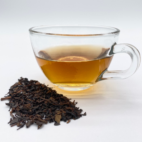 Loose leaf Vanilla Oolong Tea by Novel Tea Book Shop, showcasing golden-brown tea leaves and vanilla flavor accents