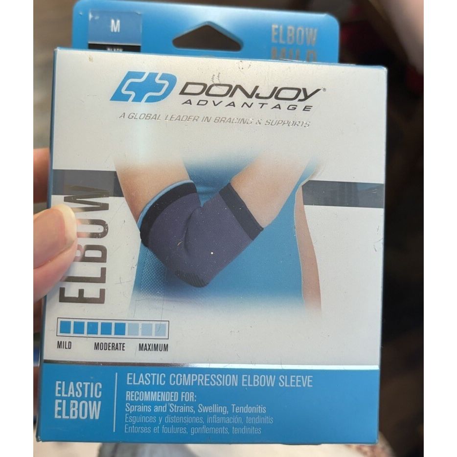 Black DonJoy Advantage elastic compression elbow sleeve, medium size, designed for support and relief in the Card Sleeves product line.