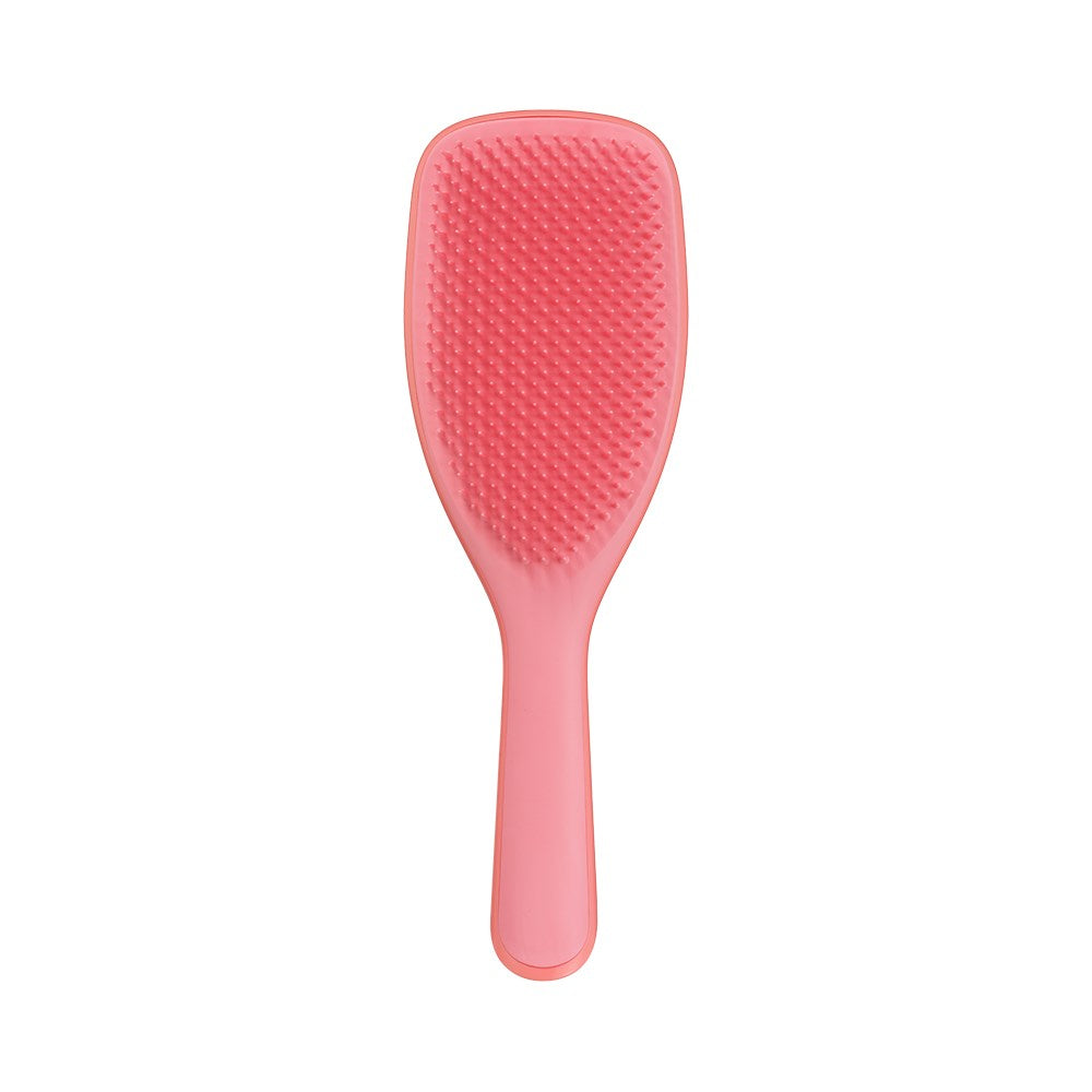 Salmon pink Tangle Teezer large detangling hairbrush with ergonomic handle for smooth, tangle-free hair.