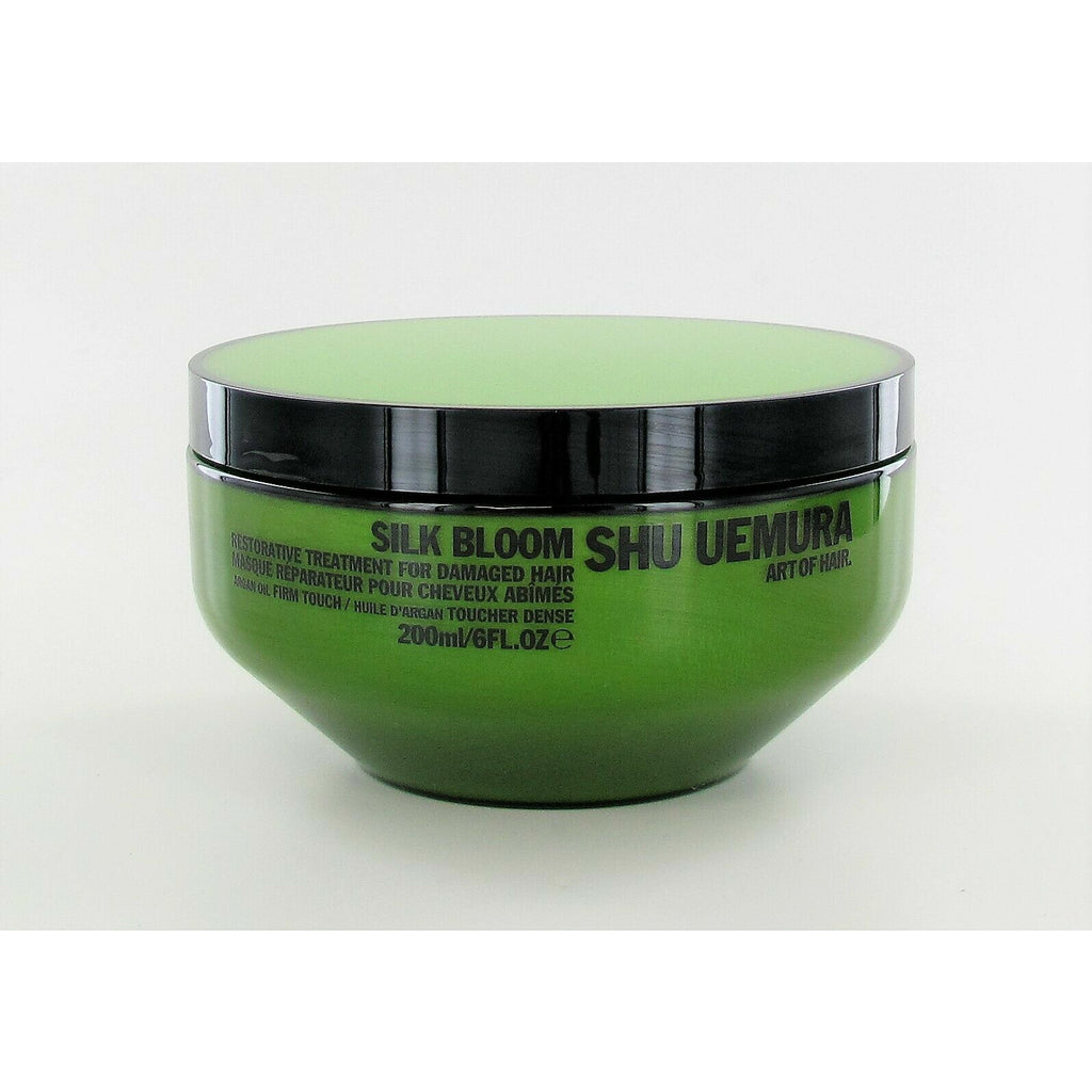 Shu Uemura Silk Bloom Restorative Treatment for hair, in a sleek bottle, designed to nourish and restore hair health.