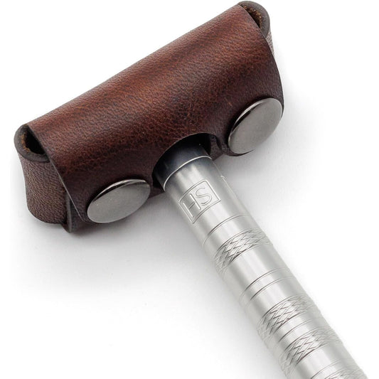 Brown leather Henson razor head cover from Pasteur Pharmacy, designed to protect and store razor heads safely.