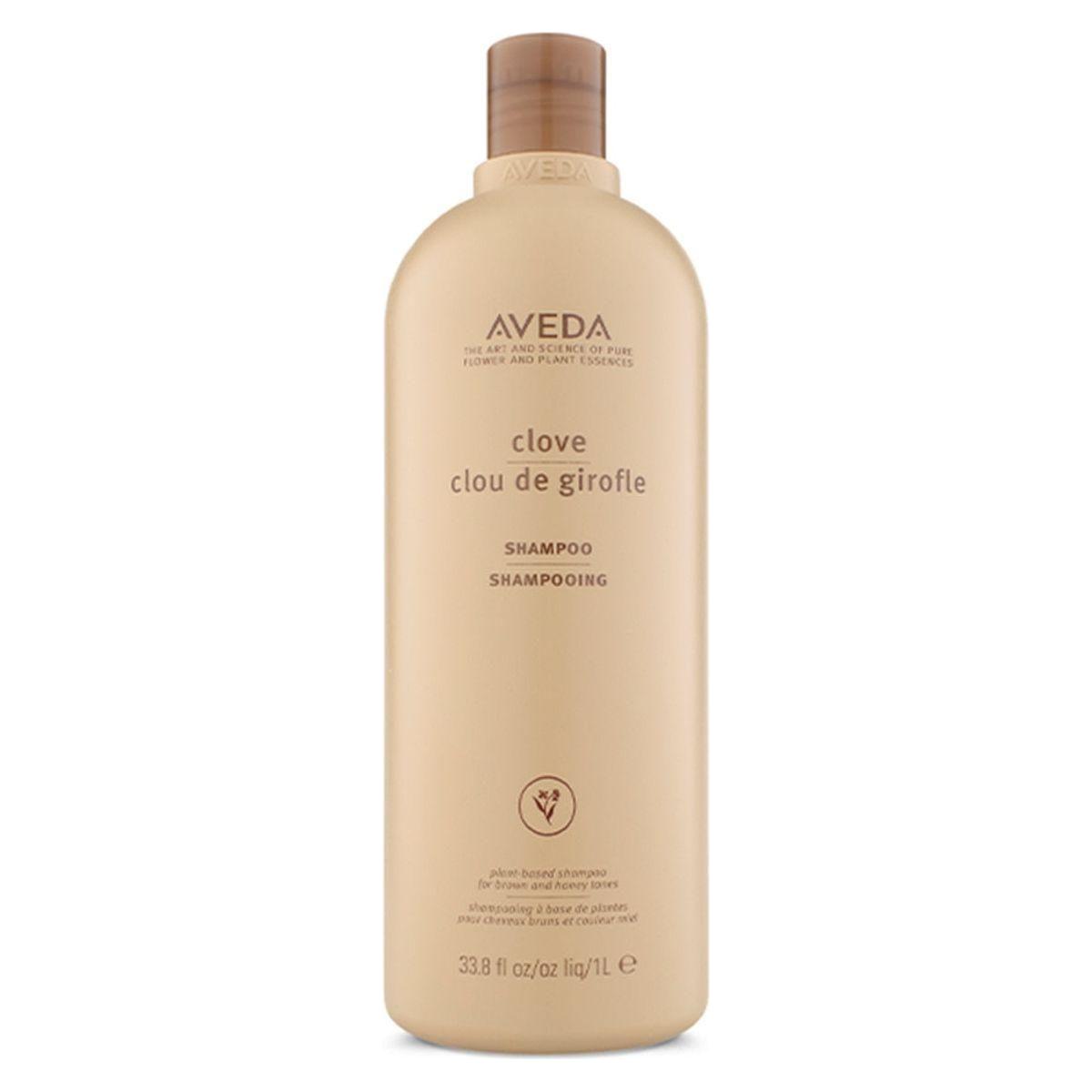 Aveda Clove Shampoo bottle, 33.8 oz, with a dark brown cap and label, displayed on a store shelf.