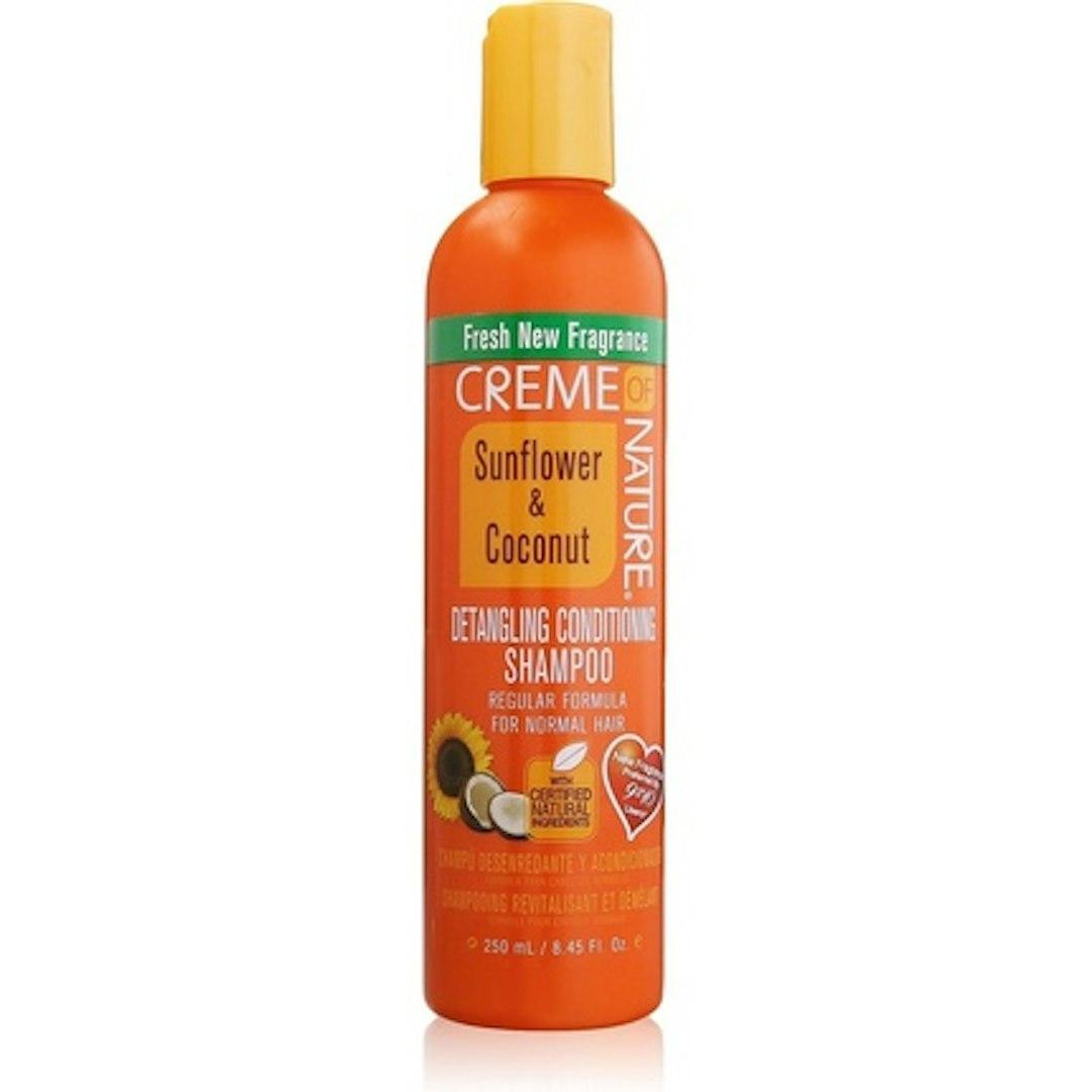 Creme of Nature shampoo bottle with sunflower and coconut for detangling and conditioning hair, displayed on a plain background.