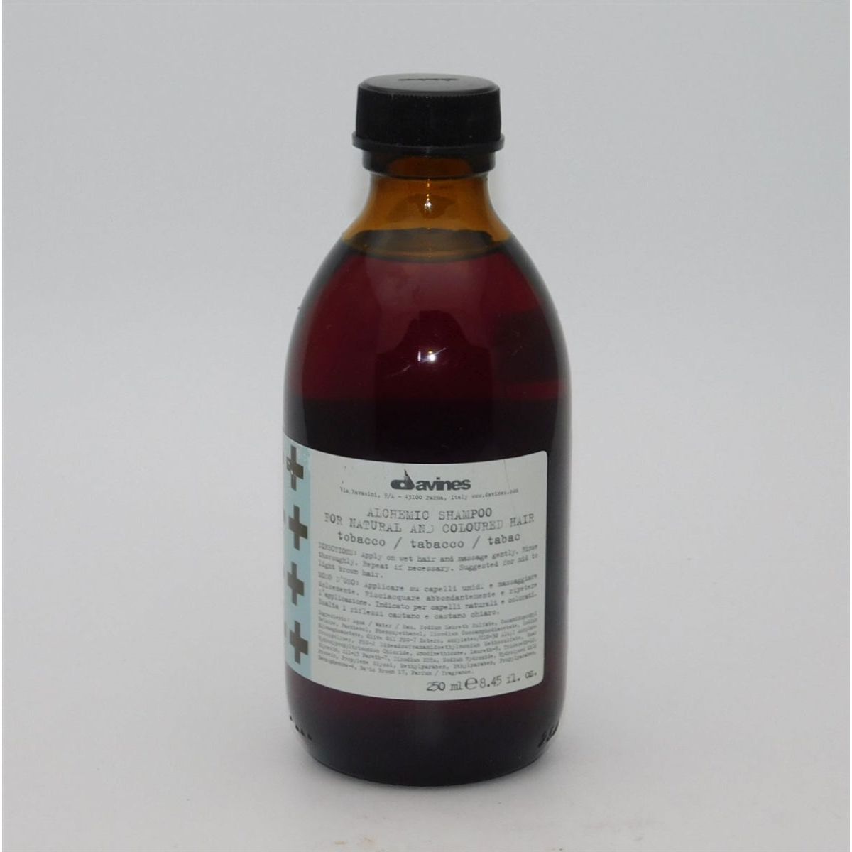 Davines Alchemic Shampoo for natural and colored hair, 8.45 oz, featuring a bottle of shampoo with label and cap.