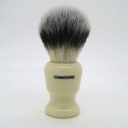 Simpson Commodore X1 Sovereign Grade synthetic fiber shaving brush with a rounded handle and soft bristles.