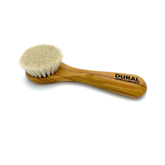Dural Olivia face and skin brush with natural goats hair and olive wood handle, used for gentle facial massage and skincare.