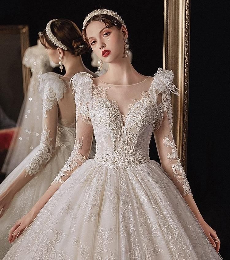 Elegant princess wedding dress with shiny pearls by EdleessFashion, featuring intricate detailing and a flowing train.