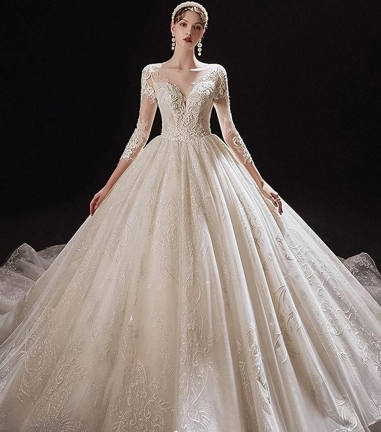 Luxurious princess wedding dress with shiny pearls by EdleessFashion, featuring intricate beadwork and flowing fabric.