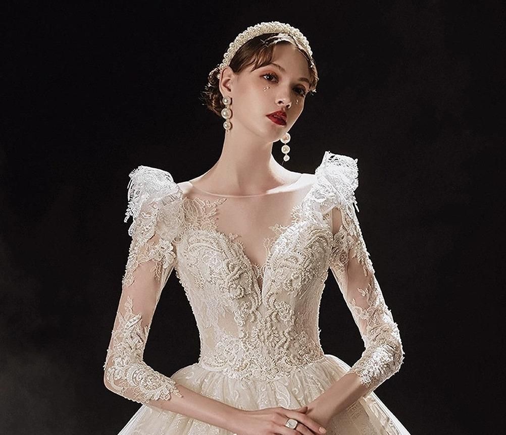 Elegant princess wedding dress with shiny pearls by EdleessFashion, featuring intricate detailing and flowing fabric.