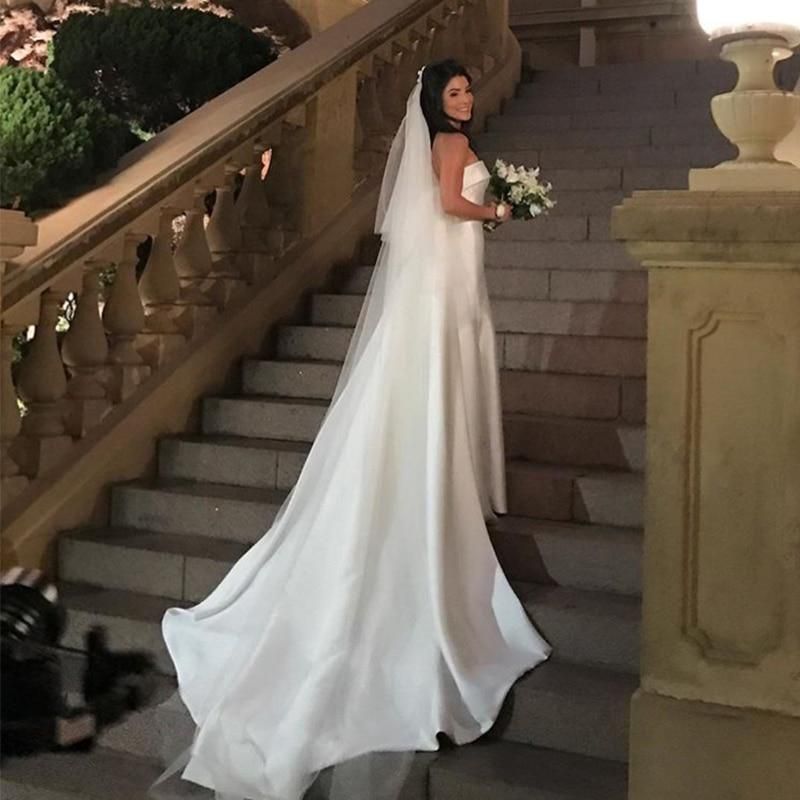 Elegant satin A-line wedding dress with strapless bodice and chapel train by EdleessFashion, shown on a model.