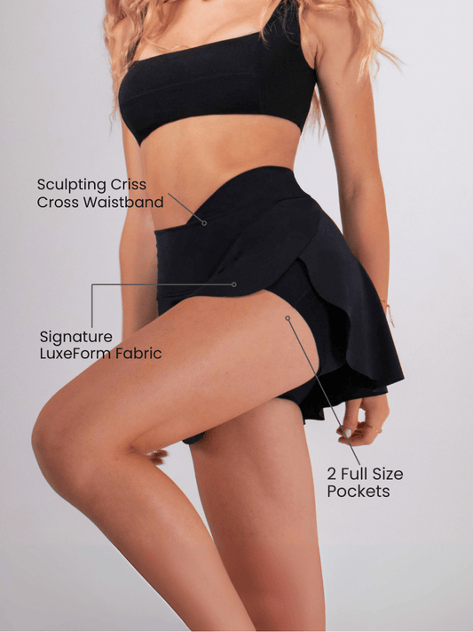 Black women's athletic skort with built-in shorts, pockets, criss-cross waist design, from Runner's Athletics LuxeForm collection.