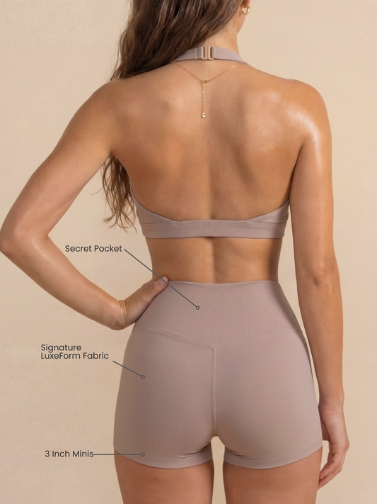 Women's mini sculpting shorts by Runner's Athletics in taupe, with a criss-cross waistband and side pocket, 3-inch length.