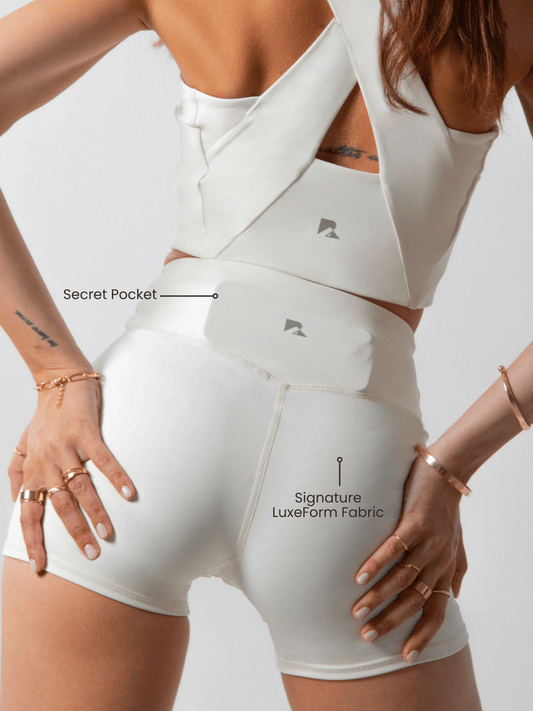Women's LuxeForm Sculpting Workout Shorts by Runner's Athletics, 5-inch beige shorts with criss-cross waistband and pocket.