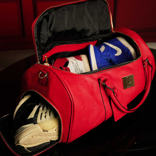 Red tumbled leather duffle bag by Sole Premise, stylish weekender bag with sturdy handles and spacious interior for travel.