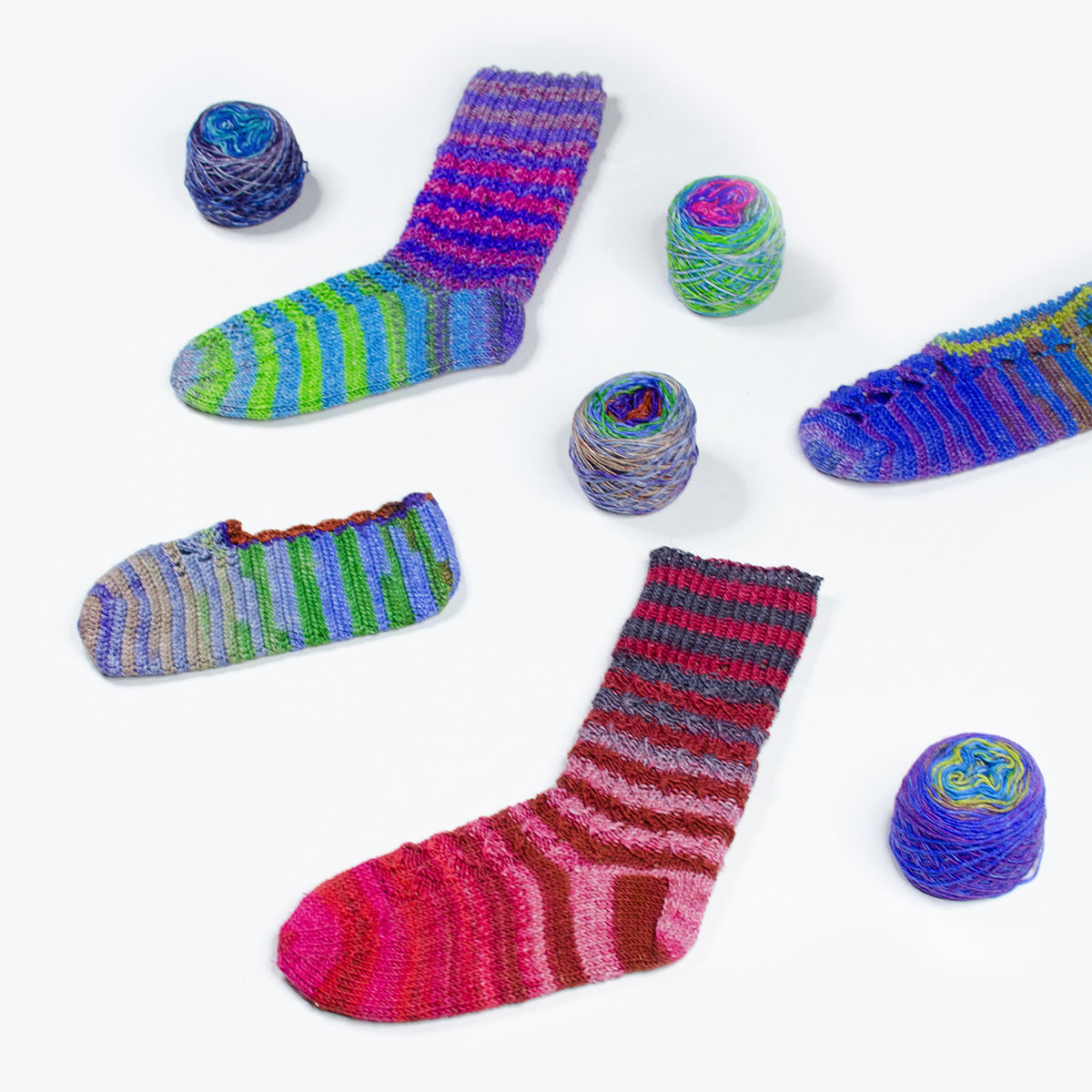 Turkish sock and slipper pattern bundle by Darn Good Yarn featuring six colorful knit and crochet sock designs.