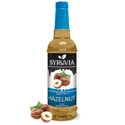 Bottle of Syruvia sugar-free hazelnut syrup with a clear label, showing the dark syrup inside on a neutral background.