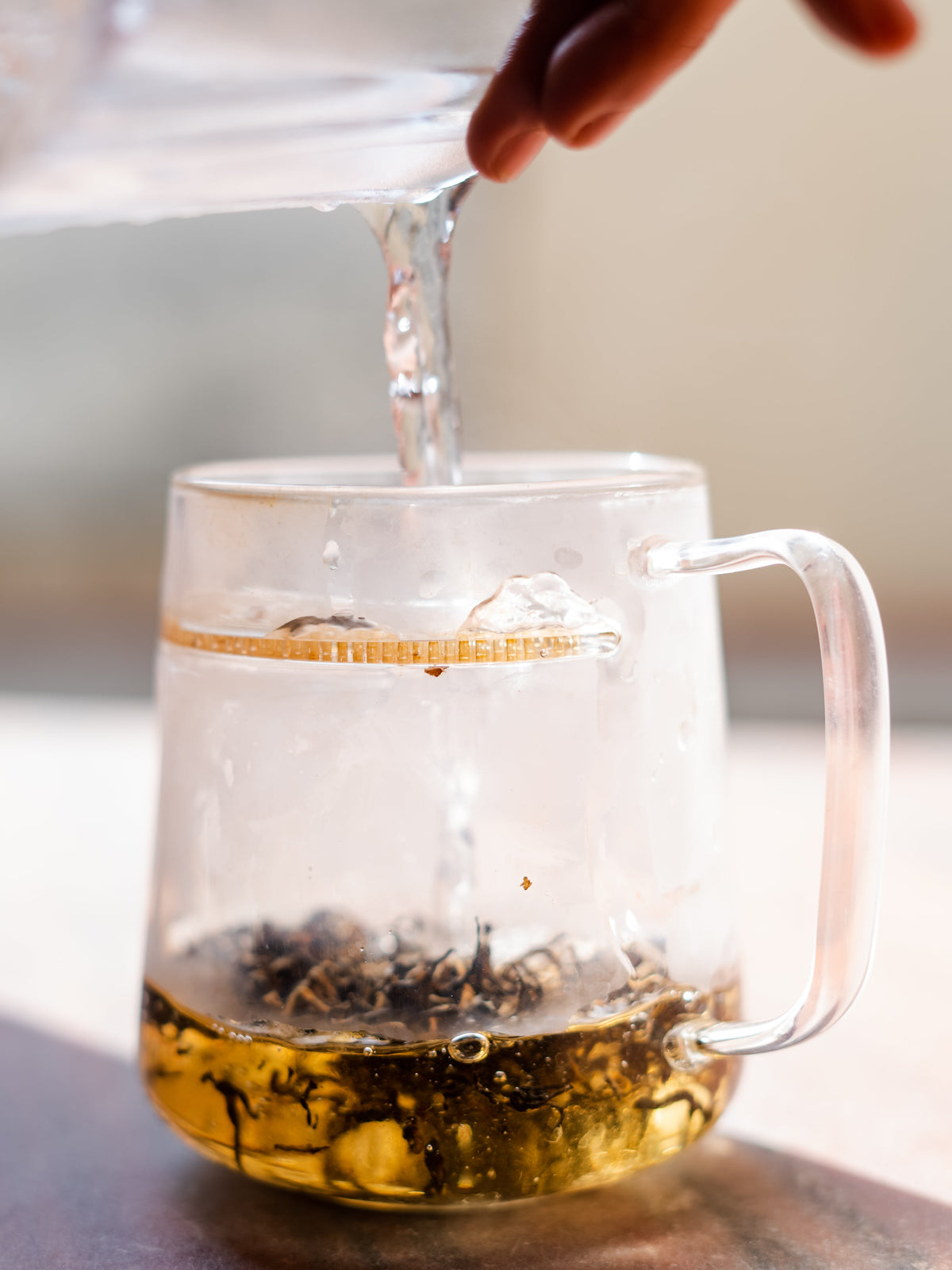 Nepal Tea The WALL® tea infuser filled with loose tea leaves, shown in a cozy kitchen setting for brewing fresh tea.