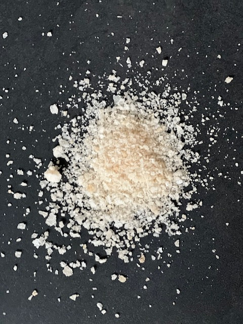 Birch smoked salt by Saltverk, gourmet seasoning with a flaky texture and smoky aroma, displayed in a clear container.