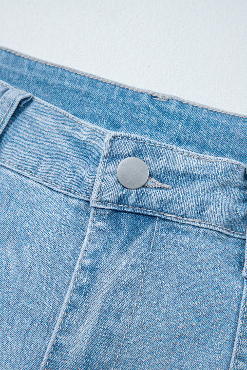 Light blue Lacey Relaxed Patch Jeans by Threaded Pear featuring distressed patches and relaxed fit for casual style.