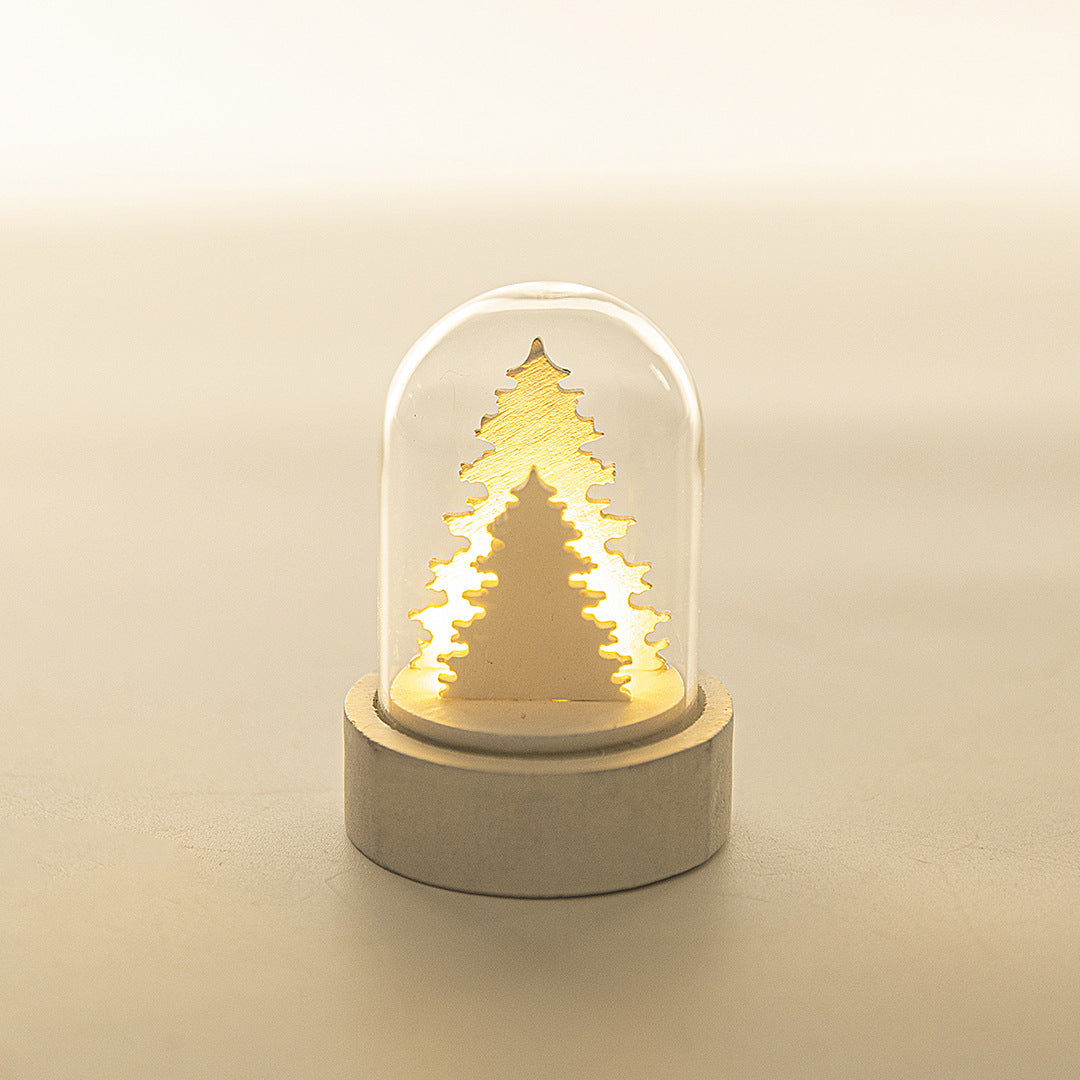 Luminous wooden Christmas house ornament decoration with glowing windows and festive holiday details
