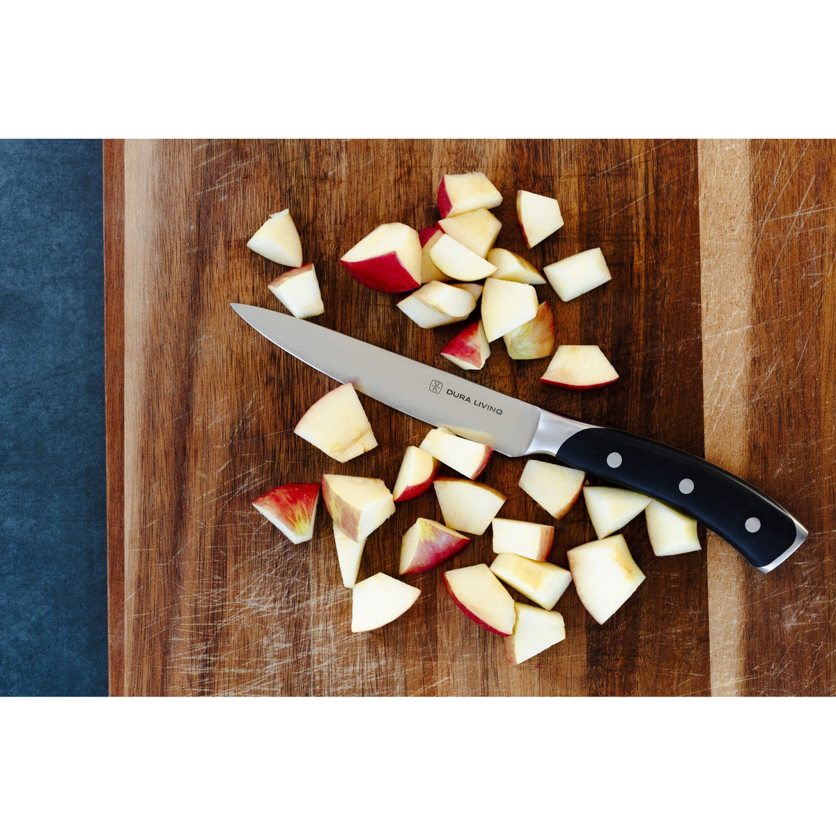 Dura Living Elite 3-piece black kitchen knife set with three stainless steel knives displayed on a wooden surface.