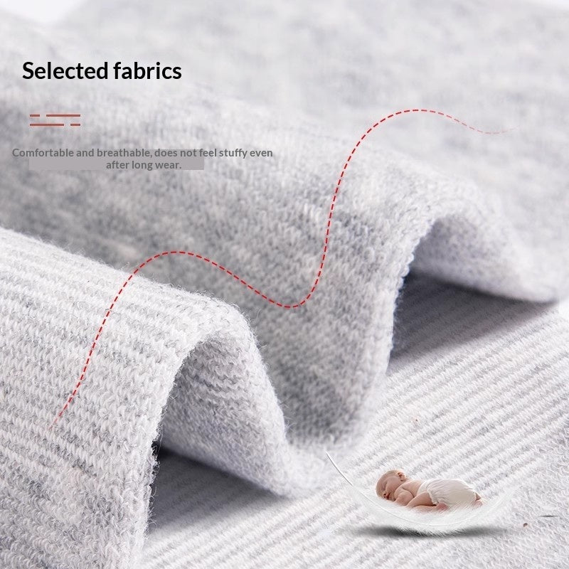 Ankle support sleeves for women, joint protection and warming socks in black fabric, pair shown flat lay