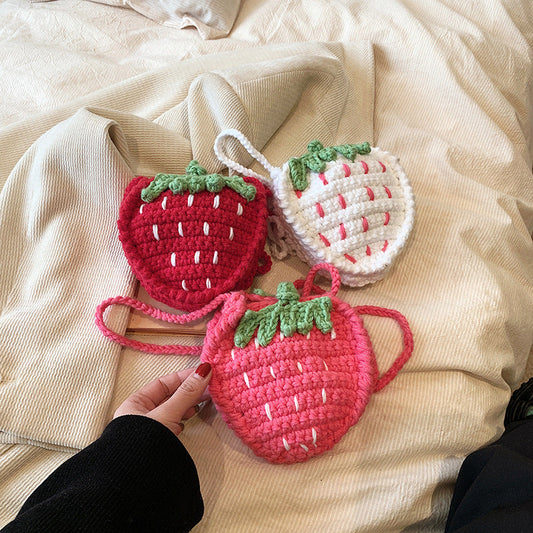 Handmade knitted children's wool strawberry crossbody bag in a cute red design