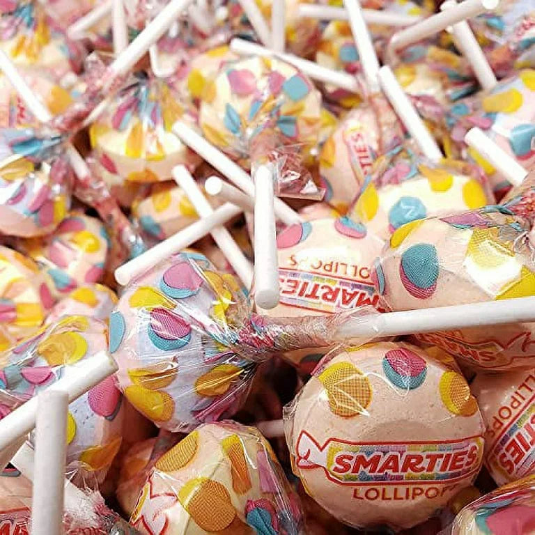 Assorted fruit-flavored Smarties lollipops in a bulk Candy In Bulk package, colorful round lollipops with sticks on a white background.