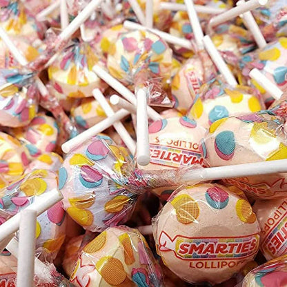 Assorted fruit-flavored Smarties lollipops in a bulk Candy In Bulk package, colorful round lollipops with sticks on a white background.