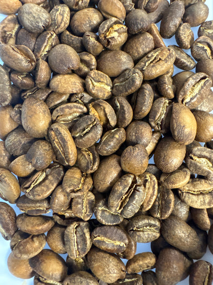 Roasted Lemon Colombia Caturra coffee beans by Good Brothers Coffee LLC arranged in a bag.