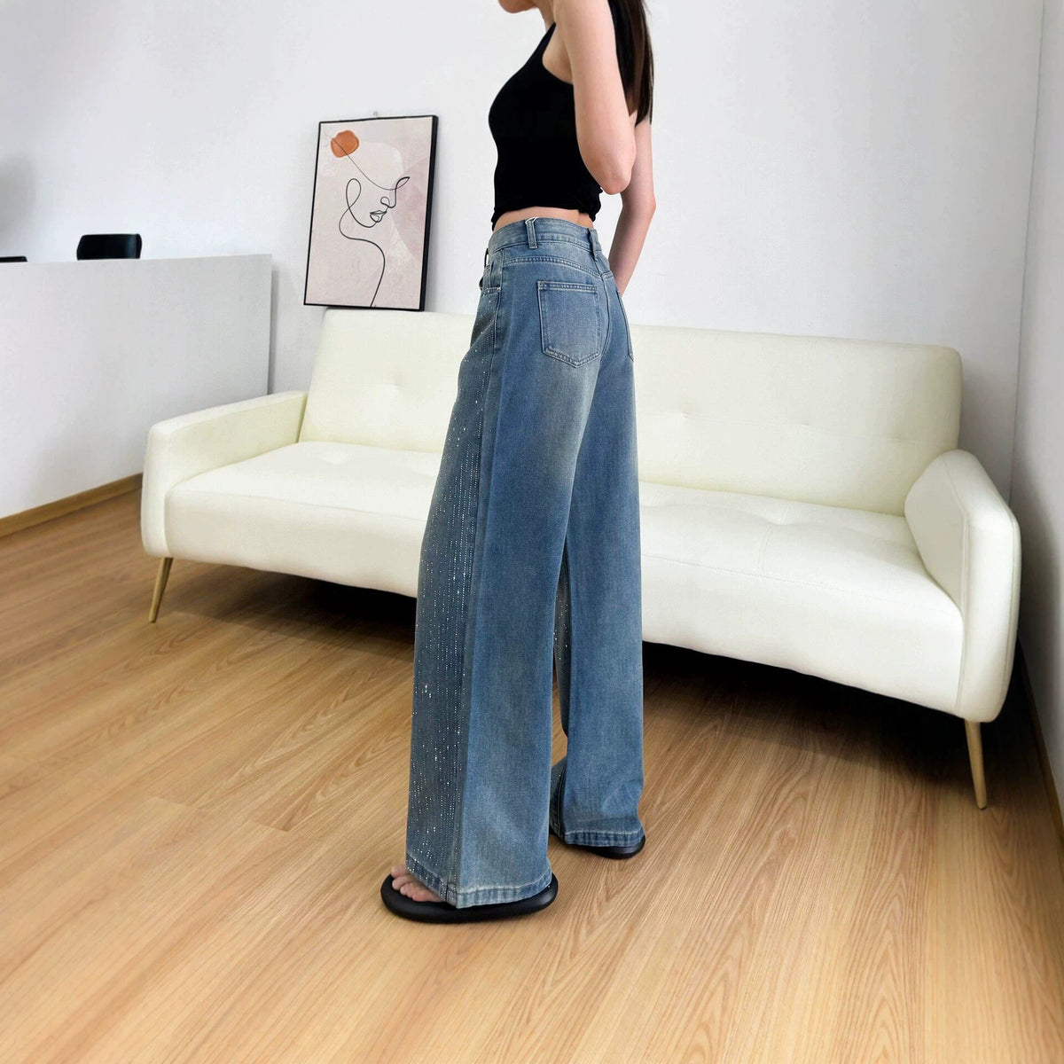 Women’s rhinestone-embellished loose-fit straight-leg jeans in denim over a white background