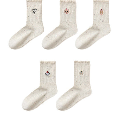 Women's embroidered ruffle-ankle socks in a soft fabric with decorative stitching and ruffled cuffs