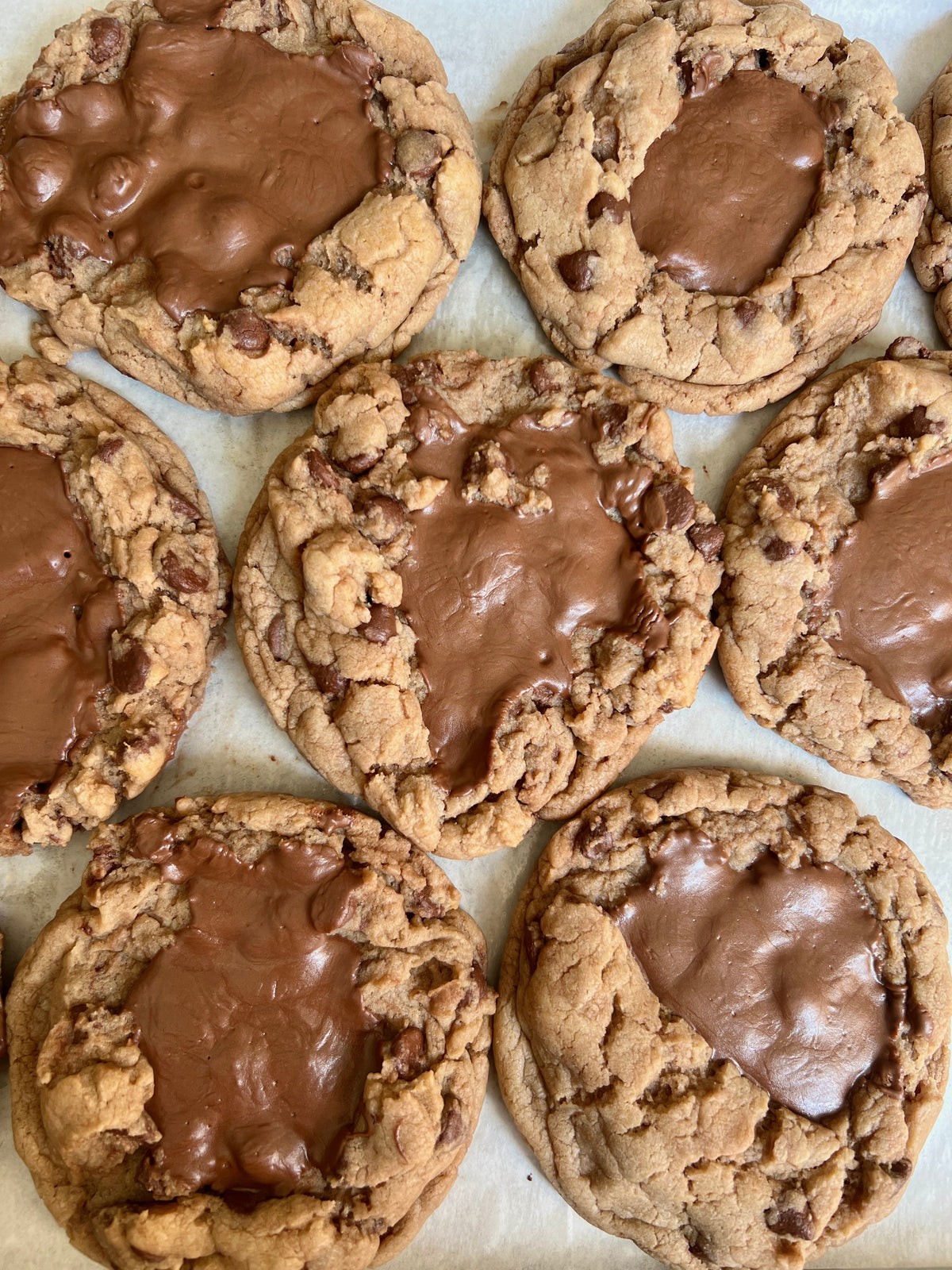 Let's Get Baked Artisan Desserts brown butter Nutella chocolate chip cookies on a plate, showcasing their rich, chewy texture.
