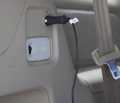 Naxa 12 Volt DC power cord with cigarette lighter socket, universal connector for TVs, shown connected to a vehicle power outlet.