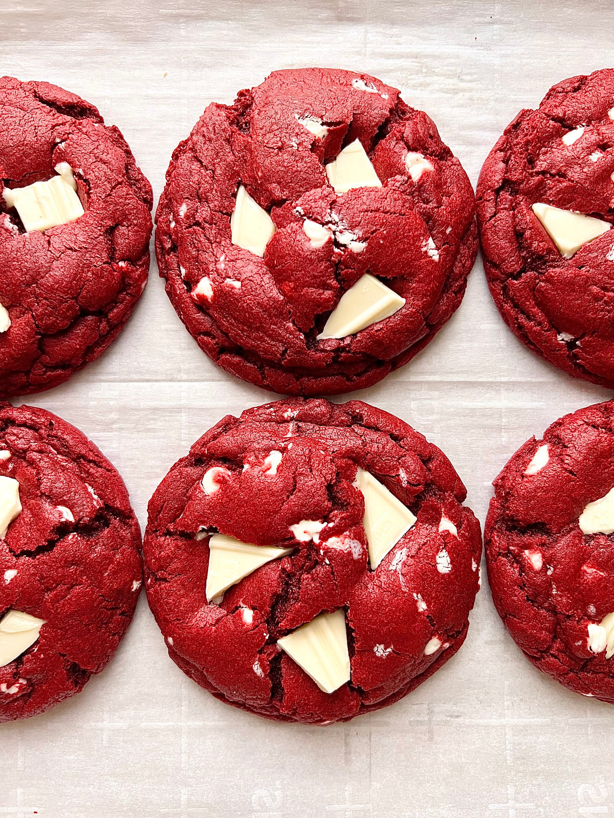 Red velvet cheesecake cookies from Let's Get Baked Artisan Desserts, featuring rich red velvet flavor and creamy cheesecake filling.
