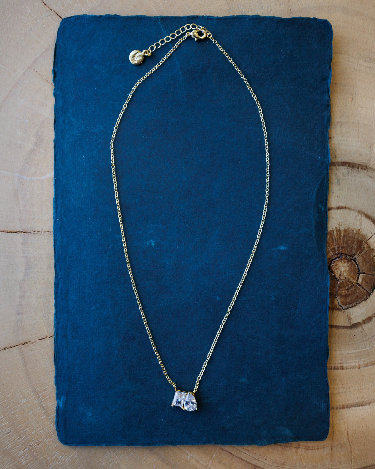 Downeast C'Est Bon Necklace featuring a delicate chain and pendant with elegant lettering, perfect for adding a stylish touch to any outfit.