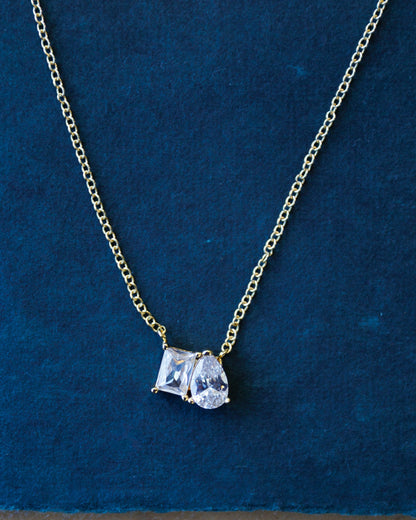 Downeast C'Est Bon necklace featuring a delicate chain and a pendant with elegant script design.