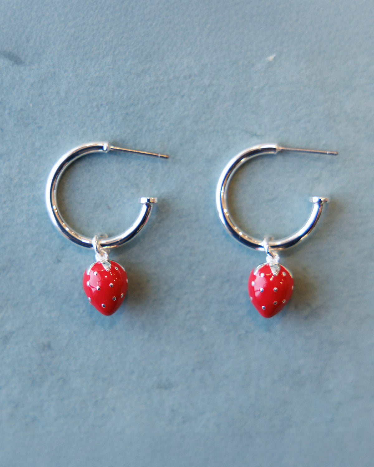 Silver Strawberry Fields Forever earrings by Downeast featuring intricate strawberry design and shiny silver finish.