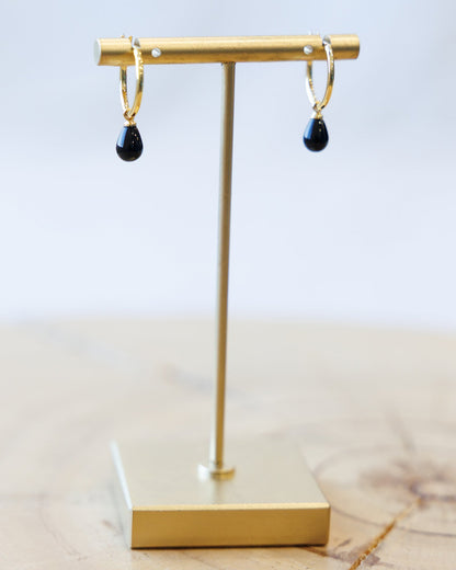 Downeast hoop and charm earrings featuring metal hoops with decorative charms, stylish jewelry for versatile wear.