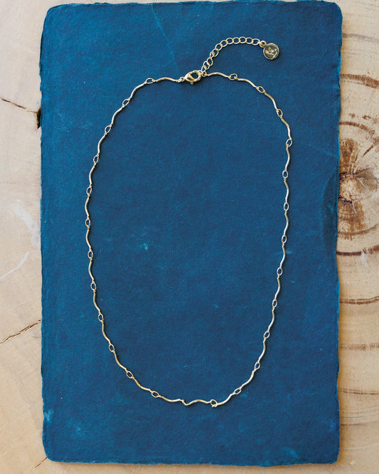 Downeast scallop necklace with layered silver scallop-shaped pendants on a delicate chain.