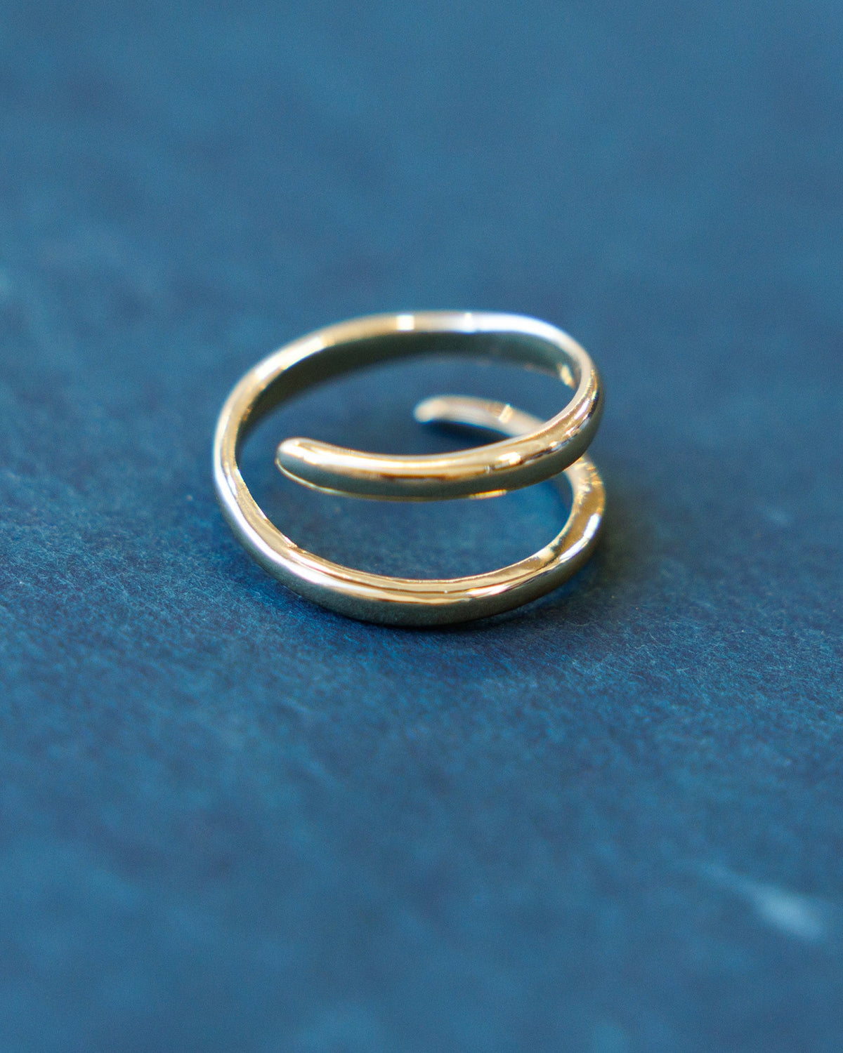 Downeast sculptured statement ring with intricate textured design, showcasing a bold, artistic jewelry piece on a neutral background.